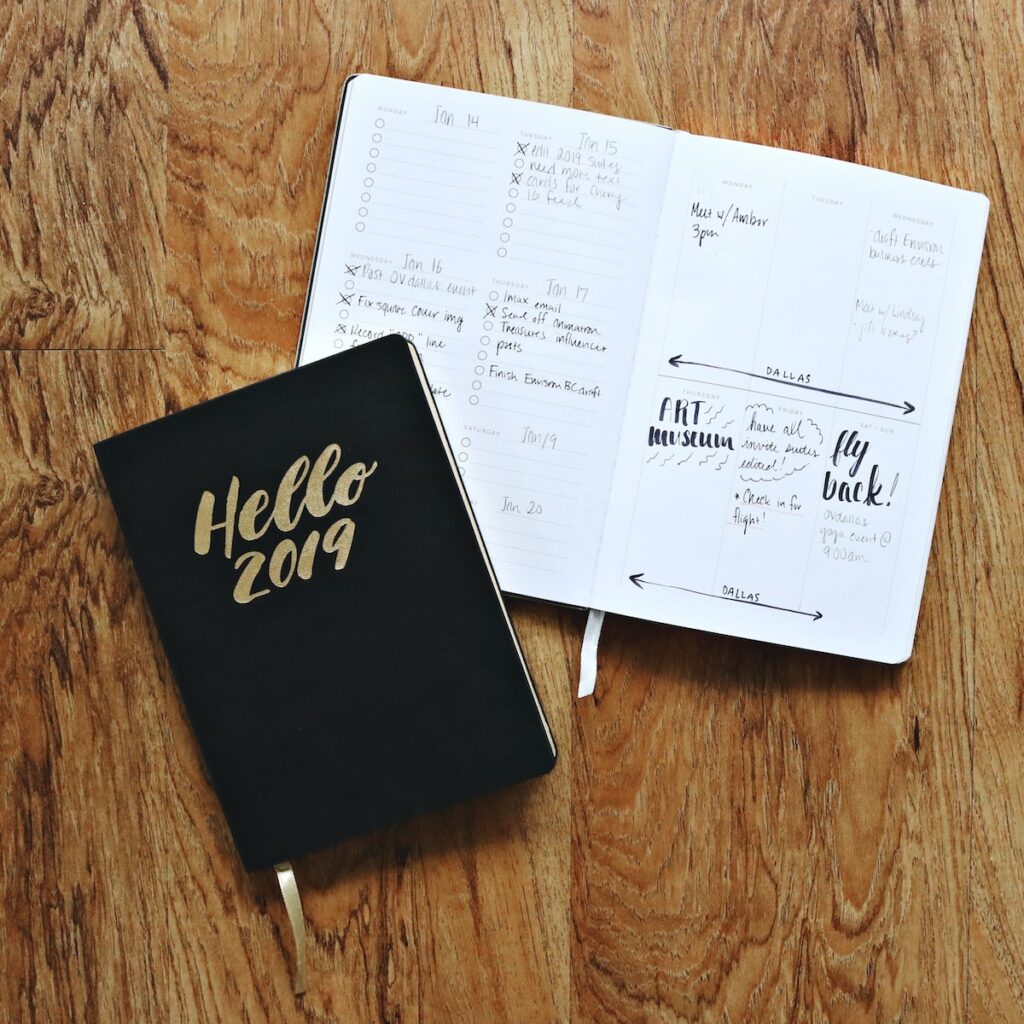 Black Hello 2019 Notebook on Brown Wooden Surface